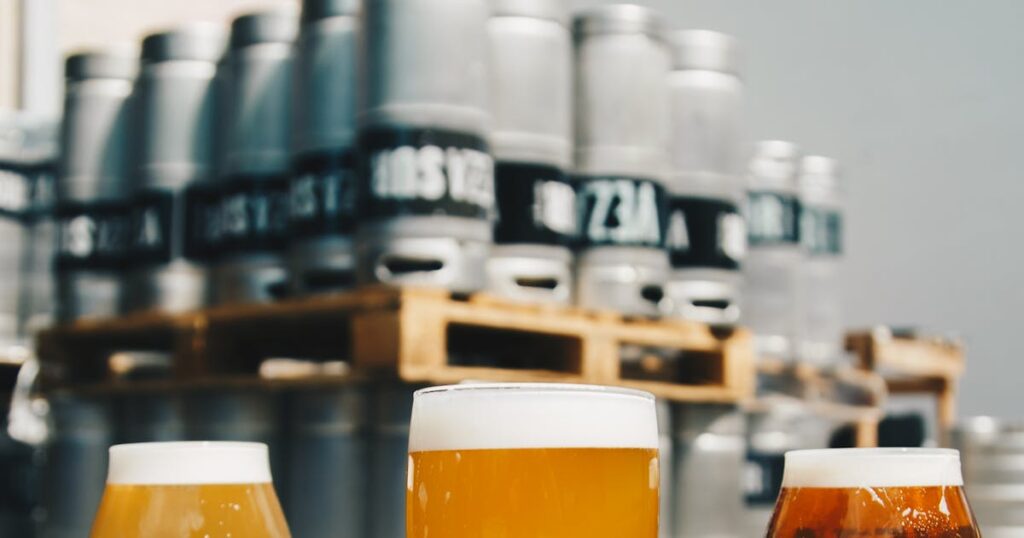 Golden beer being poured into a glass with perfect foam head, representing hybrid fermentation brewing techniques