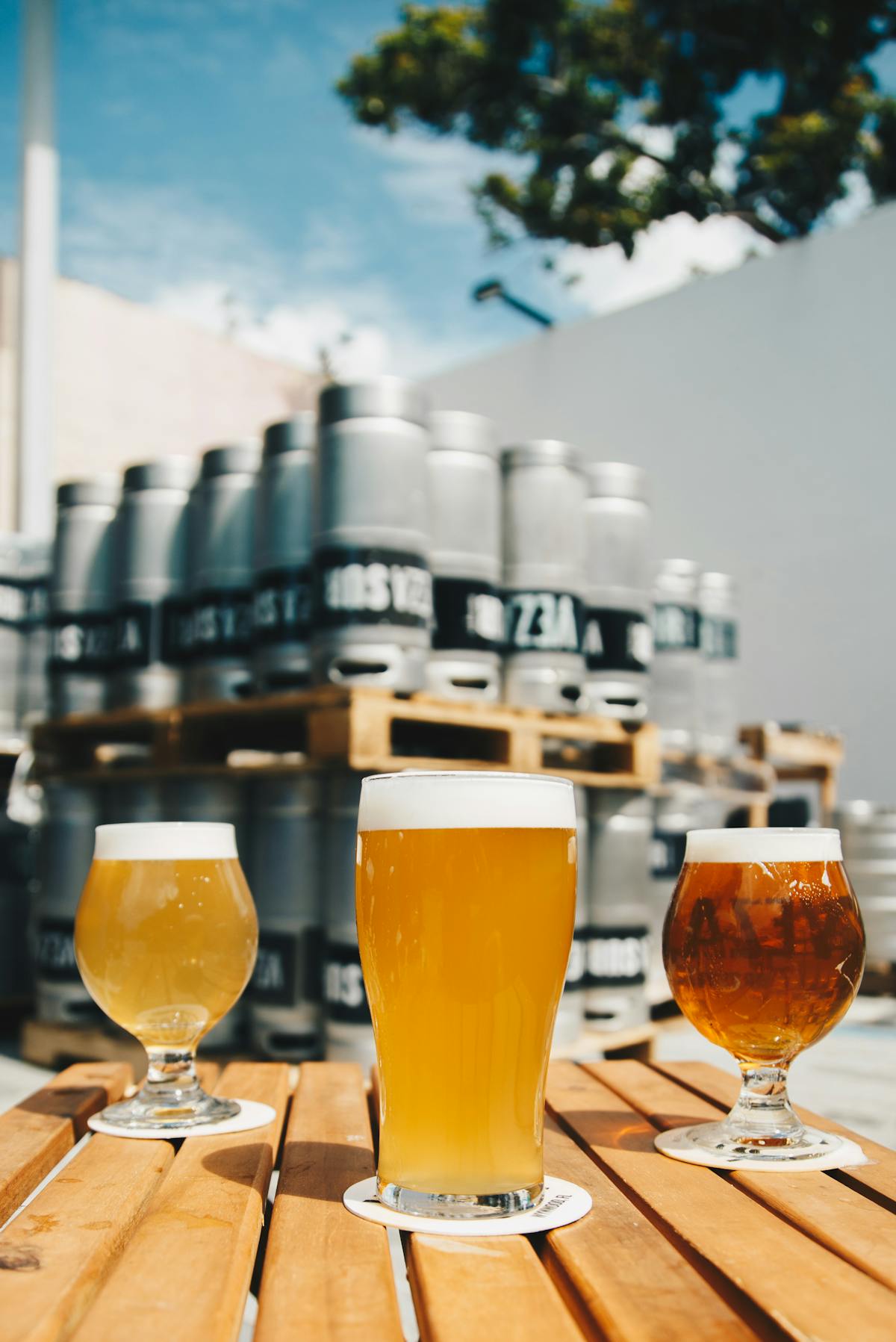 Golden grisette beer with fluffy white head in a Belgian glass