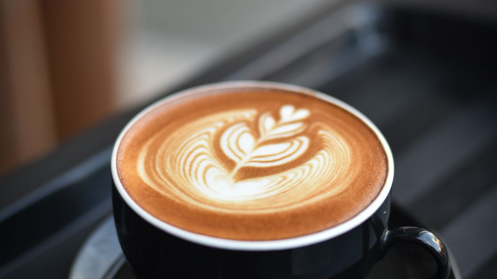 Fresh coffee beans being ground, professional grinder, UK homebrewing workspace